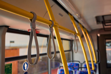 Exploring the Urban Commute People Hand Holding at a Bus Stand Utilizing Public Transportの写真素材