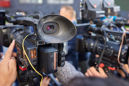 Closeup image showing someone gripping a DSLR camera with an articulated screenの写真素材