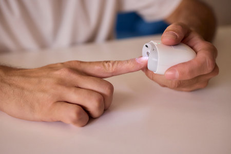 Close-up of an electric nail clipper in hand, modern personal care technology, highlighting compact...