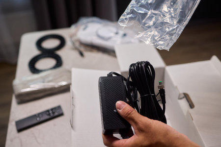 Unboxing a Brand New Electronic Device Along with Its Accessories and Remote Control