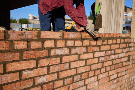 Bricklayer Hard at Work Ongoing Construction of a Residential Building Structure