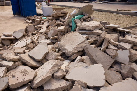 There are numerous piles of concrete debris observable at the busy construction site right now