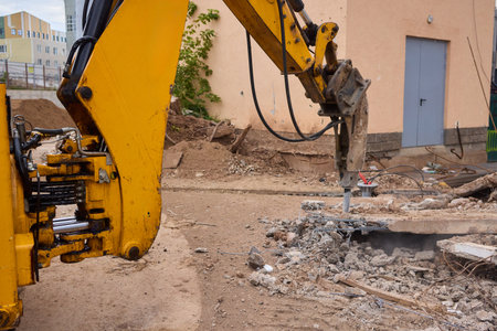 A bustling construction site filled with heavy machinery and ongoing demolition workの写真素材