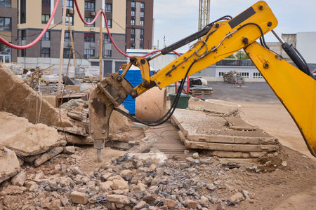A bustling construction site filled with heavy machinery and ongoing demolition workの写真素材