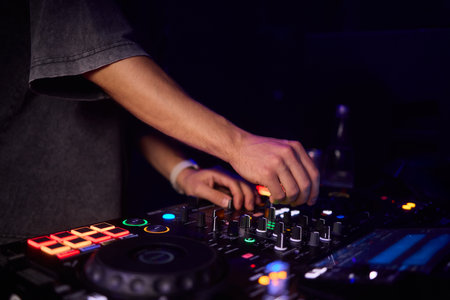 Witness the DJ mixing equipment performing live and in action at a vibrant music eventの写真素材