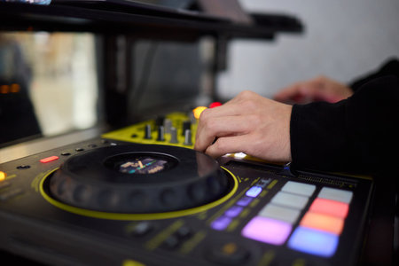 Witness the DJ mixing equipment performing live and in action at a vibrant music event