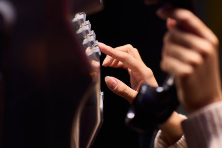 A Person Using a Payphone at Night in an Urban Setting, Highlighting Nostalgic Communication