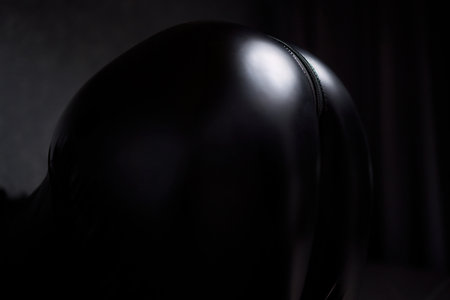 This elegant black bodysuit highlights unique, artistic details, enhancing its allure and styleの写真素材