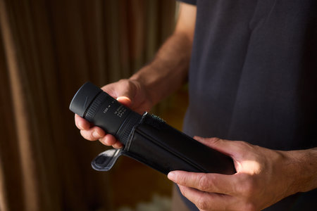 A Person Diligently Using a Telescope for Detailed Observation of the Night Sky and Beyond