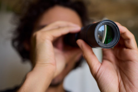 A Person Diligently Using a Telescope for Detailed Observation of the Night Sky and Beyondの写真素材