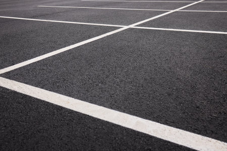 Reflective wet asphalt grid, Urban nighttime scene with textured asphalt and reflections, Cityscape at night showing glossy wet road surfaces and geometric lineの写真素材