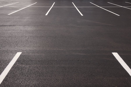 Reflective wet asphalt grid, Urban nighttime scene with textured asphalt and reflections, Cityscape at night showing glossy wet road surfaces and geometric lineの写真素材