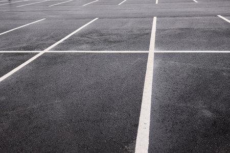 Reflective wet asphalt grid, Urban nighttime scene with textured asphalt and reflections, Cityscape at night showing glossy wet road surfaces and geometric lineの写真素材