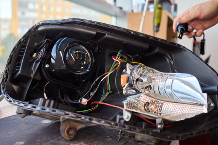 Careful precision is essential when installing a car headlight assembly for optimal performanceの写真素材
