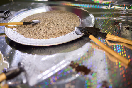 Grain in basin, Rustic setting with grain, Natural light highlighting coarse grain, Wooden spoon resting on grain in rustic kitchen environmentの写真素材