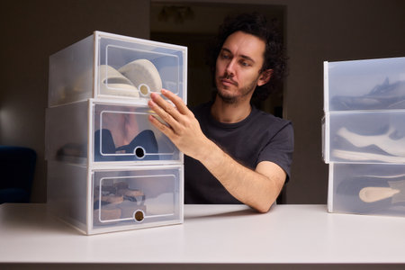 Organizing clear shoe containers effectively, Arranging transparent footwear storage with focus and style, Meticulous placement of feedthrough shoe boxes in minimalistの写真素材