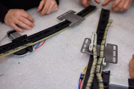 Focused technician conducts precise motor repairs, Dedicated technician methodically finetunes small...
