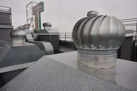 Steel turbine vents on rooftop, Metal ventilation units on city roof top, Closeup of industrial...