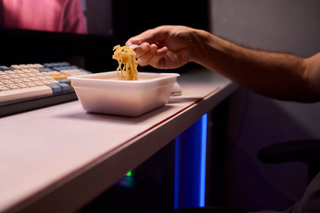 Casual moment captured during evening stream with ambient glow and home studio backgroundの写真素材