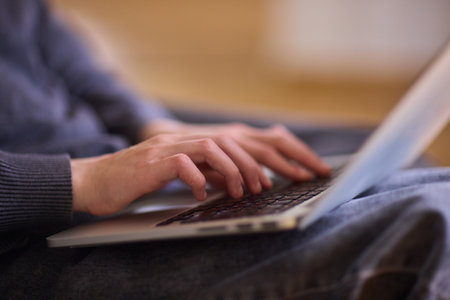 Determined individual with cerebral palsy immersed in educational activities indoors, Courageous woman with cerebral palsy concentrates on studying at home with dedicationの写真素材