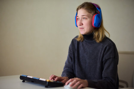 Relaxed woman with gaming controller, Young woman plays video game comfortably at home, Female gamer...