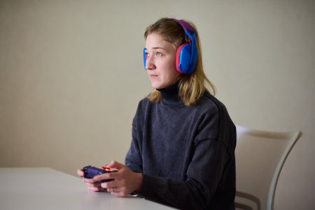 Casual female gamer, Relaxed woman with gaming controller, Young woman plays video game comfortably...