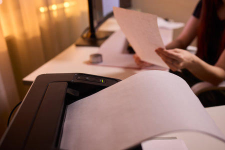Closeup of professional reviewing agreement documents diligently, Dedicated editor engaged in...