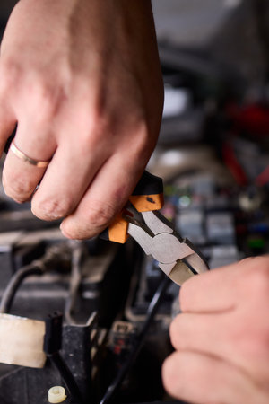 Closeup of technician attaching sensor wire to electrical port, Detailed view of installer carefully positioning pins within small automotive connector during maintenanceの写真素材