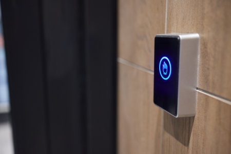 This is a modern smart touch sensor device installed on a wall, featuring a blue LED indicator