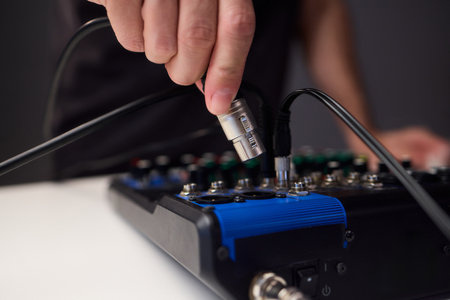 Fitting cables into professional studio gear, Attaching connectors carefully on live music setup,...