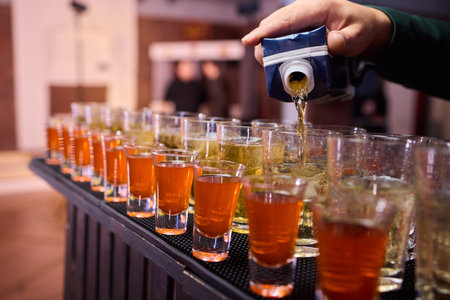 Vibrant party beverages, Festive setup with lively drink arrangements and busy bartenders, Array of...