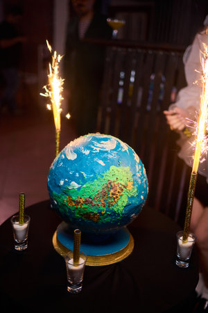 Luxurious earth themed cake showcased with sparkling fireworks and decorations, Extravagant...