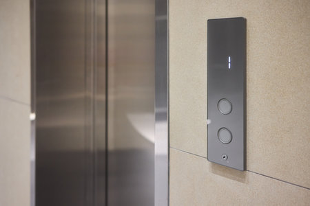 High-tech elevator panel featuring tactile buttons and illuminated screen, Advanced elevator...