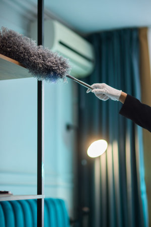 Focused staff meticulously inspect to guarantee pristine room conditions. Team members collaborate efficiently to deliver spotless room presentation through careful attentionの写真素材