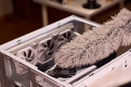 Cleaning computer components with brush. Closeup of dusty electronics being cleaned. Detailed shot...