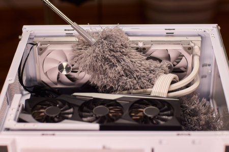 Cleaning computer components with brush. Closeup of dusty electronics being cleaned. Detailed shot...