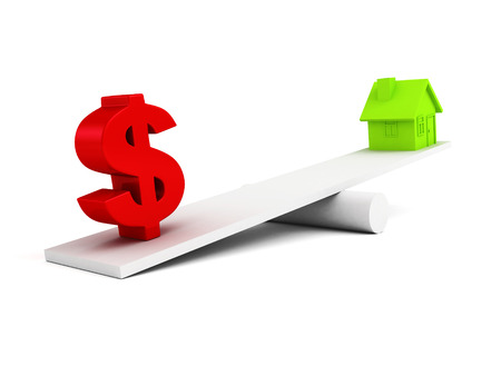 dollar symbol and house icon on scale balanceの写真素材