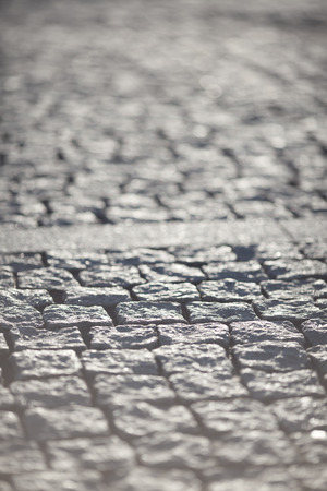 Abstract Background of Old Cobblestone Pavement Road Under Sunshineの写真素材