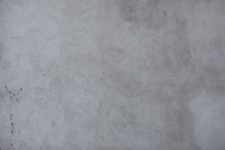 Texture of gray dirty worn concrete wall with cracksの写真素材