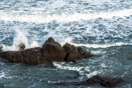 Ocean waves hitting rocks. Storm weather sea view photo
