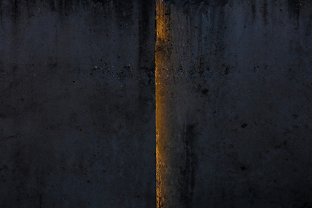 Old concrete wall with sun light from seam. Industrial backgroundの写真素材