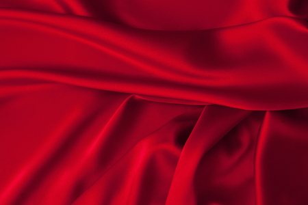 Luxury red shiny satin fabric cloth abstract wavy backgroundの写真素材