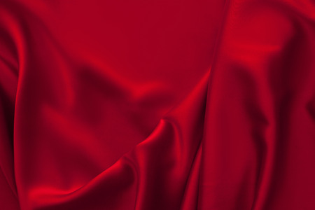 Luxury red shiny satin fabric cloth abstract wavy backgroundの写真素材