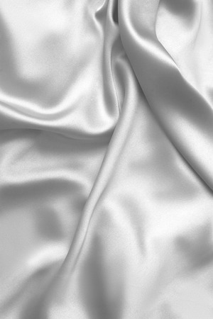 Rippled white silk fabric satin cloth waves glamour backgroundの写真素材