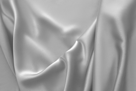 Rippled white silk fabric satin cloth waves glamour backgroundの写真素材