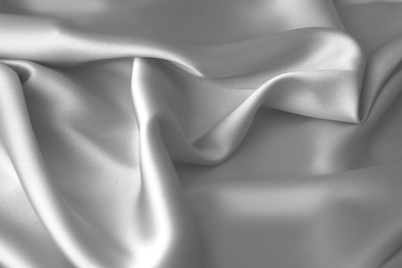 Rippled white silk fabric satin cloth waves glamour backgroundの写真素材