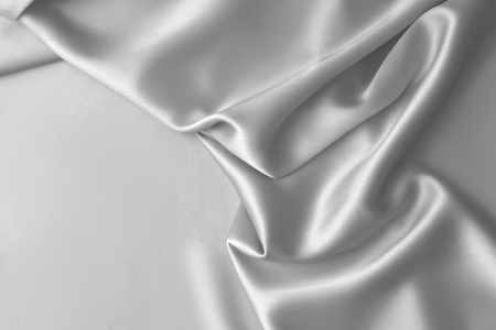 Rippled white silk fabric satin cloth waves glamour backgroundの写真素材