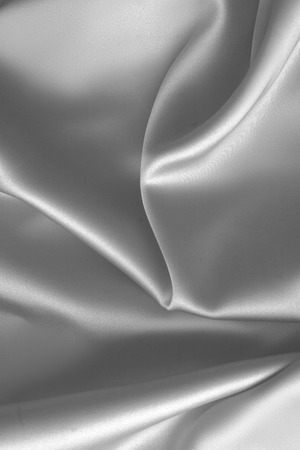 Rippled white silk fabric satin cloth waves glamour backgroundの写真素材
