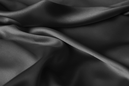 Black luxury wavy rippled glossy silk drapery cloth fabric. Abstract backgroundの写真素材