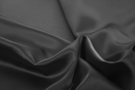 Black luxury wavy rippled glossy silk drapery cloth fabric. Abstract backgroundの写真素材